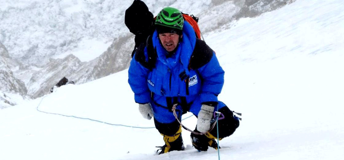 Austrian mountaineer Gerfried Göschl summiting a mountain wearing Dachstein Woolwear